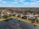 Bird's eye view of houses near a lake and lush trees at 2984 Cedar Glen Pl, Oviedo, FL 32765