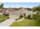 Single-story home with red door and attached garage at 2984 Cedar Glen Pl, Oviedo, FL 32765