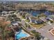 Aerial view of community pool and surrounding houses near a lake at 2984 Cedar Glen Pl, Oviedo, FL 32765