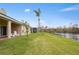 Backyard with pond view, lawn, and palm tree at 2984 Cedar Glen Pl, Oviedo, FL 32765