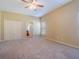 Spacious bedroom with carpet floors and double doors to closet at 2984 Cedar Glen Pl, Oviedo, FL 32765