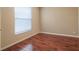 Simple bedroom with hardwood floors and a window with blinds at 2984 Cedar Glen Pl, Oviedo, FL 32765