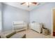 Bedroom featuring a crib, dresser, and rocking chair at 2984 Cedar Glen Pl, Oviedo, FL 32765