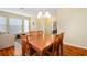 Bright dining room with hardwood floors, a wooden table, and chandelier at 2984 Cedar Glen Pl, Oviedo, FL 32765