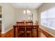 Dining area with hardwood floors, a wooden table and chairs, and a chandelier at 2984 Cedar Glen Pl, Oviedo, FL 32765