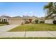 One-story house with a red door, attached garage, and well-maintained lawn at 2984 Cedar Glen Pl, Oviedo, FL 32765