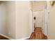 Clean hallway with wood flooring leading to laundry and bedrooms at 2984 Cedar Glen Pl, Oviedo, FL 32765