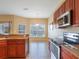 Kitchen boasts stainless steel appliances and wood cabinets at 2984 Cedar Glen Pl, Oviedo, FL 32765