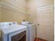 Laundry room with washer, dryer, and ample shelving at 2984 Cedar Glen Pl, Oviedo, FL 32765