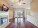 Living room with fireplace, hardwood floors and sliding doors to a lake view at 2984 Cedar Glen Pl, Oviedo, FL 32765