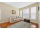 Living area with beige sofa, decorative rug, and large windows at 2984 Cedar Glen Pl, Oviedo, FL 32765