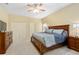 Spacious main bedroom with large bed, double closets and wood furniture at 2984 Cedar Glen Pl, Oviedo, FL 32765