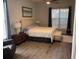 King bed, chair, and wood-look floors in bedroom at 3315 Newbliss Cir, Ormond Beach, FL 32174