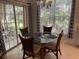 Bright dining room with glass table and access to a patio at 3315 Newbliss Cir, Ormond Beach, FL 32174