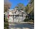 House exterior with a two-car garage and American flag at 3315 Newbliss Cir, Ormond Beach, FL 32174