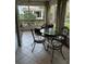 Screened porch with glass-top table and metal chairs at 3315 Newbliss Cir, Ormond Beach, FL 32174