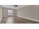 Spacious bedroom with laminate wood flooring and large window at 3433 Glossy Leaf Ln, Clermont, FL 34711