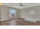 Spacious bedroom with large window, ceiling fan, and hardwood floors at 3433 Glossy Leaf Ln, Clermont, FL 34711