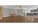 Open concept dining room with hardwood floors and kitchen view at 3433 Glossy Leaf Ln, Clermont, FL 34711