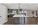 Modern kitchen with large island, stainless steel appliances, and wine cooler at 3433 Glossy Leaf Ln, Clermont, FL 34711