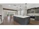 Modern kitchen with an island and dark gray cabinetry at 3433 Glossy Leaf Ln, Clermont, FL 34711