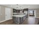 Modern kitchen with large island, stainless steel appliances, and wine cooler at 3433 Glossy Leaf Ln, Clermont, FL 34711