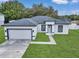 Newly built home with gray roof, white exterior, and a paved driveway at 3999 Sw 129Th St, Ocala, FL 34473