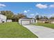 White house with gray roof and a spacious lawn, showcasing curb appeal at 3999 Sw 129Th St, Ocala, FL 34473