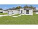 Newly built home with gray roof, white exterior, and a paved walkway at 3999 Sw 129Th St, Ocala, FL 34473