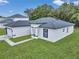 Modern house with gray roof and white exterior, showcasing curb appeal at 3999 Sw 129Th St, Ocala, FL 34473