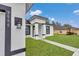 Close-up view of house entrance with modern lighting and landscaping at 3999 Sw 129Th St, Ocala, FL 34473