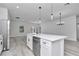 Kitchen island with white quartz countertop, sink, and dishwasher at 3999 Sw 129Th St, Ocala, FL 34473