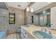 Bathroom with double vanity, blue sinks, and tiled walls at 4108 Downeast Ln, Windermere, FL 34786