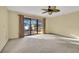 Bedroom with sliding doors leading to a deck and lake view at 4108 Downeast Ln, Windermere, FL 34786