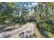 Driveway entrance with mature trees and landscaping at 4108 Downeast Ln, Windermere, FL 34786