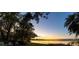 Peaceful lakefront view at sunset with lush greenery at 4108 Downeast Ln, Windermere, FL 34786