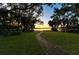 Brick pathway meandering towards a tranquil lake view at 4108 Downeast Ln, Windermere, FL 34786