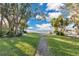 Pathway leads to waterfront with lush landscaping and trees at 4108 Downeast Ln, Windermere, FL 34786