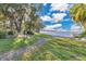 Relaxing waterfront view with grassy area and seating at 4108 Downeast Ln, Windermere, FL 34786