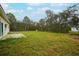 Large backyard with grassy area and a patio at 431 Rainbow Ct, Kissimmee, FL 34759