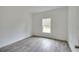 Bright bedroom featuring wood-look tile floors and a window at 431 Rainbow Ct, Kissimmee, FL 34759