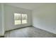 Spacious bedroom with wood-look tile floors and large window at 431 Rainbow Ct, Kissimmee, FL 34759