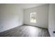 Bedroom with gray tile floors and a window with wooded view at 431 Rainbow Ct, Kissimmee, FL 34759