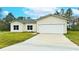 Single-story home with attached garage and landscaped yard at 431 Rainbow Ct, Kissimmee, FL 34759