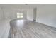 Bright living room with wood-look tile floors and large window at 431 Rainbow Ct, Kissimmee, FL 34759