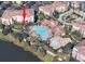 Aerial view of the building including the pool, clubhouse, lake, and surrounding landscaping at 5012 Shoreway Loop # 10207, Orlando, FL 32819