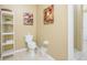 Bathroom featuring a toilet, shelving unit and artwork at 5012 Shoreway Loop # 10207, Orlando, FL 32819