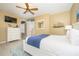 Bedroom with queen bed, dresser, and ocean view at 5012 Shoreway Loop # 10207, Orlando, FL 32819