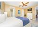 Bedroom featuring a bed, dresser, ceiling fan and attached bathroom at 5012 Shoreway Loop # 10207, Orlando, FL 32819