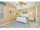 Bright bedroom with queen bed and ceiling fan at 5012 Shoreway Loop # 10207, Orlando, FL 32819